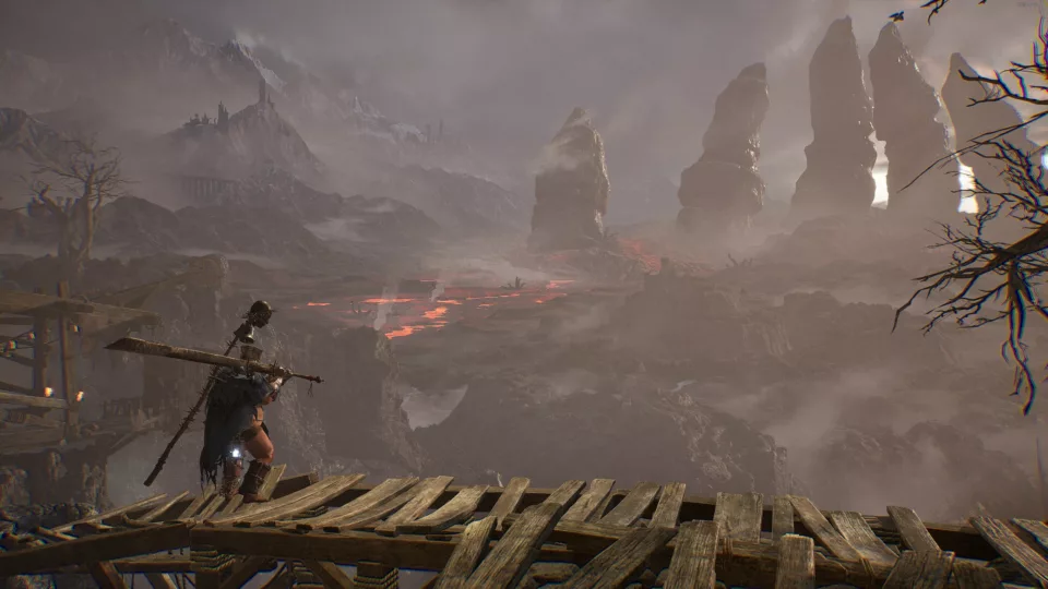 Armoured Knight stands on a walkway overlooking the land in front of him. Lava and mountains in the shape of a hand can be seen.